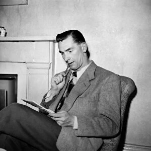 Jackie Milburn, at the Buxton Palace hotel, in pensive mood, writing to his wife Laura