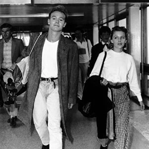 Jason Donovan actor singer with Kylie Minogue actress singer walk through airport