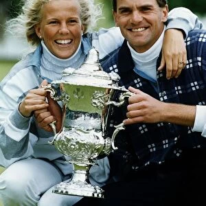 Jesper Parnevik and unidentified woman holding up trophy golf