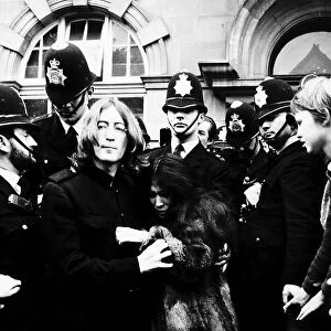 John Lennon Beatles Singer with wife Yoko Ono surrounded by police