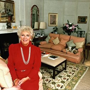 Katie Boyle columnist relaxing at home wearing red top