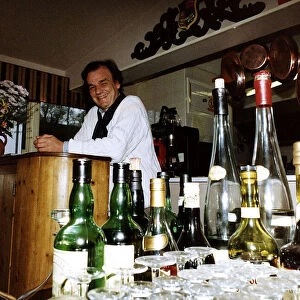Keith Floyd TV Cook Presenter and Chef look out over a restaurant from behind the bar