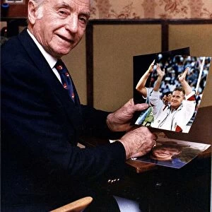 Legendary English footballer Sir Stanley Matthews holding a photograph of Paul Gascoigne