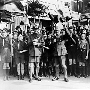 Lord Baden-Powell founder of the Boy Scouts Cubs with group of boys waving hats in