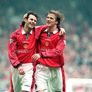 Manchester United footballer Ryan Giggs celebrates a goal with teammate David Beckham