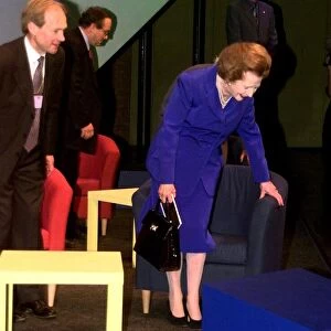 Margaret Thatcher the former Prime Minister of Britain examines one of the armchairs