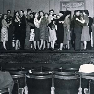 Men and women try to forget the war for a few hours seen here dancing on the stage of