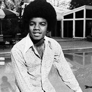 Michael Jackson Singer sitting on the edge of swimming pool circa 1975
