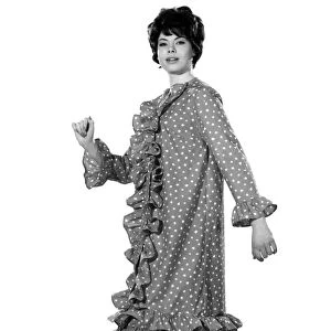 Model Jennifer White wearing a knee length spotty dress with frills