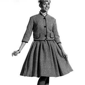 Model Jo Waring wearing a buttoned up jacket and matching skirt. October 1961 P007828