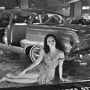 Model sits beside a Humber car at the British International Motor Show in London 19th