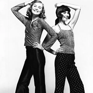 Two models show off the latest in lurex jumpers and flares
