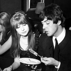 Paul McCartney Singer and guitar player with the Beatles sits with Jane Asher, circa 1964