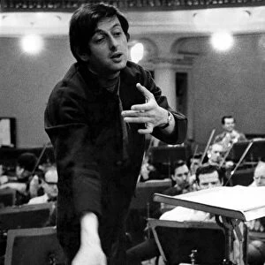 Pictures of conductor Andre Previn in action during a record session with the London