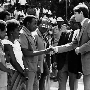 Prince Andrew at Dar Es Salaam during a visit to East Africa shaking hands with students