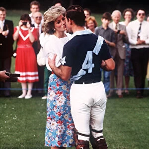 Prince Charles, Prince of Wales and Princess Diana, Princess of Wales kiss as they attend