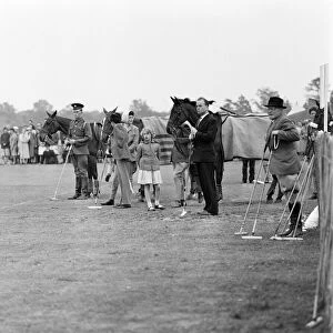 Princess Anne watches her father play polo at Windsor Great Park. 17th May 1959