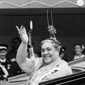 Queen Salote of Tonga endearing herself to the cheering crowds by riding through
