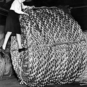Rope making at a London factory. A huge coil of rope weighing three