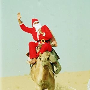 Santa Claus riding a camel holding sack