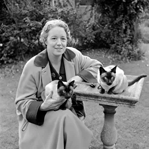 Siamese cats with their owners. 1954 A120-009