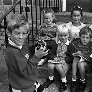Smile please! Six-year-old Adam Bedford puts his reporter "colleagues"