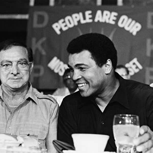 A smiling Muhammad Ali at pre fight press conference for his upcoming fight with Larry