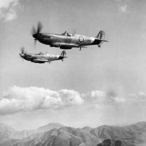 Spitfire fighter planes of the RAF keeping a dawn to dusk patrol over the mountainous