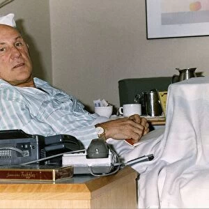 Stirling Moss ex Grand Prix racing driver lying in a hospital bed after breaking his leg