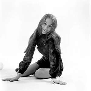 Woman poses in the studio wearing a black mini dress. December 1969 Z11850-001