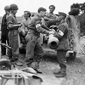 World War 2 August 1944 British and German Red Cross personnel meet over a howitzer
