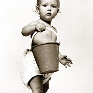 Four year old Oliver Cowley aged 18 months poses with a bucket as part of a horoscope