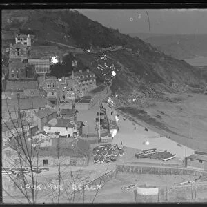 East Looe Beach & seafront with washing drying on East Cliff