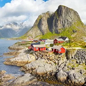 Red wooden fishermen`s huts rorbu, Lofoten Island landscape, Norway