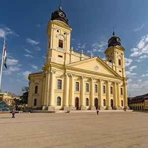 Reformed Great Church in Debrecen city, Hungary. Old city center with statues and flower garden
