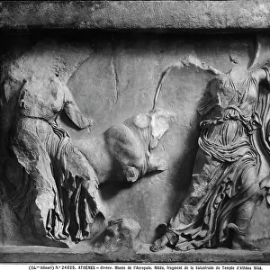 Relief depicting the goddess of Victory, Nike, and a bull, from the balustrade of the Temple of Athena Nike, in the Acropolis Museum in Athens