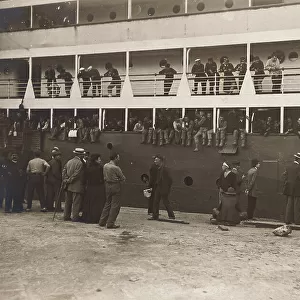 Soldiers and civilians departing on a ship for America