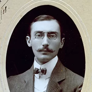Three-quarter-length portrait of a young elegant man with glasses and bow-tie