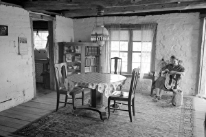 ADOBE HOUSE, 1940. A woman in an adobe house in Pie Town, New Mexico ADOBE HOUSE, 1940. A woman in an adobe house in Pie Town, New Mexico