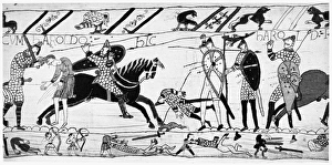 BAYEUX TAPESTRY. Passing an unarmed Englishman being struck down, the Norman cavalry BAYEUX TAPESTRY. Passing an unarmed Englishman being struck down, the Norman cavalry