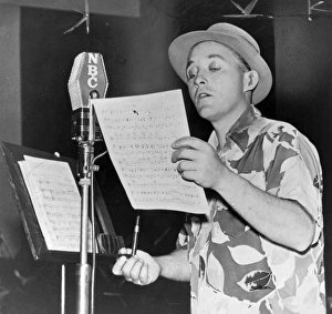BING CROSBY (1903-1977). American singer and actor. Performing into an NBC microphone BING CROSBY (1903-1977). American singer and actor. Performing into an NBC microphone