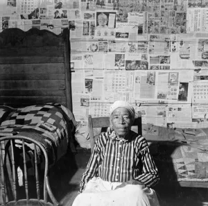 BIRACIAL WOMAN, 1941. A former slave in her home near Greensboro, Alabama BIRACIAL WOMAN, 1941. A former slave in her home near Greensboro, Alabama