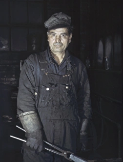 BLACKSMITH, 1943. Daniel Anastazia, a blacksmiths assistant, at the roundhouse BLACKSMITH, 1943. Daniel Anastazia, a blacksmiths assistant, at the roundhouse