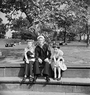 CENTRAL PARK, 1942. A sailor with girls in Central Park, New York City CENTRAL PARK, 1942. A sailor with girls in Central Park, New York City