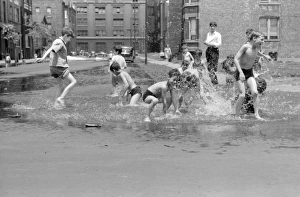 CHICAGO, 1941. Boys playing the the water from a fire hydrant in Chicago, Illinois CHICAGO, 1941. Boys playing the the water from a fire hydrant in Chicago, Illinois