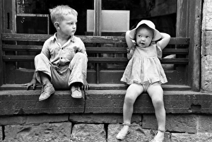 CHILDREN, 1940. Children of gold miners sitting on a store window sill, Mogollon, New Mexico CHILDREN, 1940. Children of gold miners sitting on a store window sill, Mogollon, New Mexico