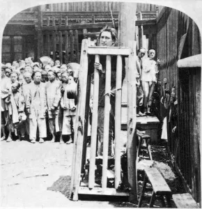 CHINA: PUNISHMENT, c1900. A criminal in Shanghai, China being punished by confinement in a cage CHINA: PUNISHMENT, c1900. A criminal in Shanghai, China being punished by confinement in a cage