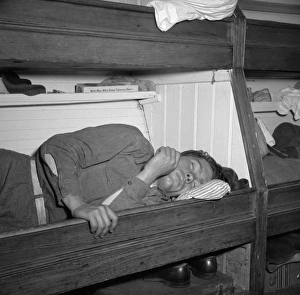 FISHERMAN, 1943. A young fishermen taking a nap on board the fishing boat Alden FISHERMAN, 1943. A young fishermen taking a nap on board the fishing boat Alden