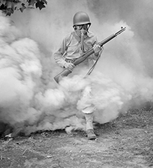 GAS MASK, 1942. Sergeant George Camblair learning how to use a gas mask in a practice GAS MASK, 1942. Sergeant George Camblair learning how to use a gas mask in a practice