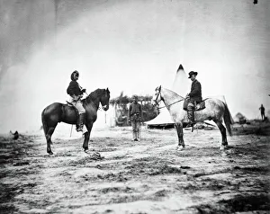 GEORGE CUSTER (1839-1876). American army officer. Custer, left, as a Captain in the Union Army GEORGE CUSTER (1839-1876). American army officer. Custer, left, as a Captain in the Union Army